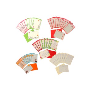 May include: A collection of greeting cards and envelopes in assorted colours. Cards display floral and animal illustrations, with text in multiple languages. Envelopes are red, green, orange, and cream.