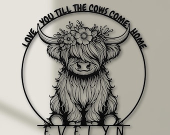 May include: Black metal wall art featuring a Highland cow with floral accents. The cow is within a circular frame with the text "LOVE YOU TILL THE COWS COME HOME" and the name "EVELYN" below.