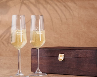 May include: Two champagne flutes with the words "Groom James" and the date "08.08.2020" etched on them. The flutes are in a wooden box with a gold latch.