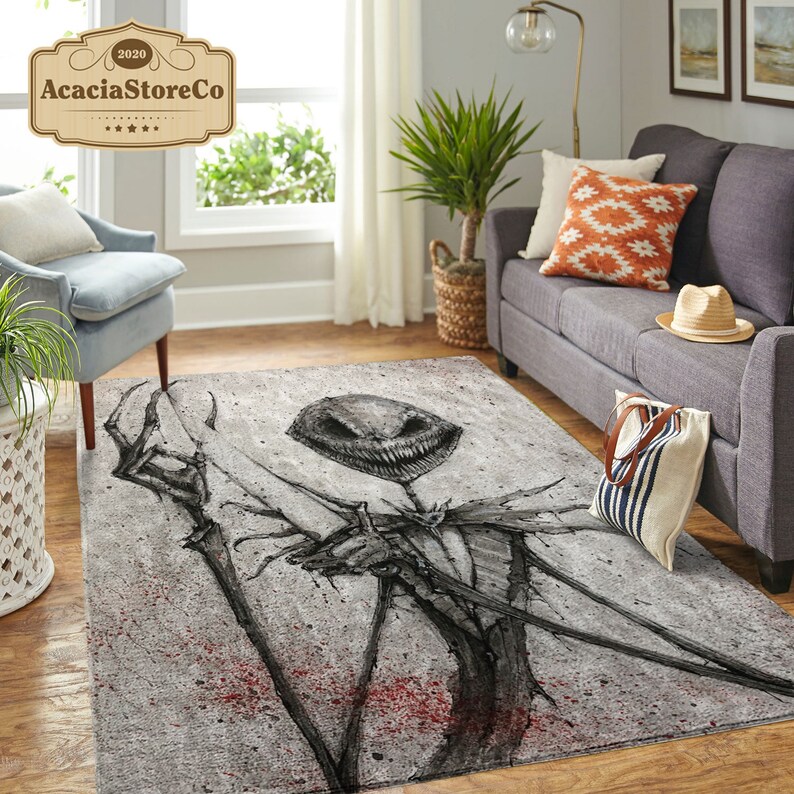 May include: A rectangular area rug featuring a skeletal character with a wide grin, set against a gray, textured background with red splatter details. The rug's design is a dark, artistic illustration.