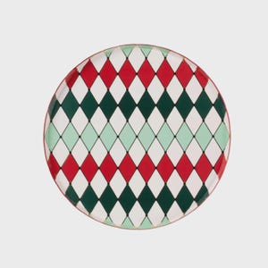 May include: A round decorative plate with a red, green, white, and light green diamond pattern. The plate has a red rim and a gold-colored edge. The design is symmetrical and covers the entire surface of the plate.