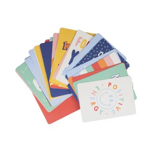 May include: A collection of colorful cards with various designs and text. The cards feature a range of colors, including yellow, blue, pink, and green. Some cards have text like "ENERGY" and "POSITIVE" with a smiley face. The cards are arranged in a fan shape.