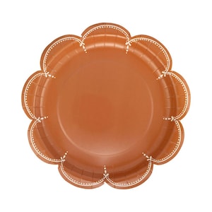 May include: A round, scalloped-edge paper plate in a solid terracotta orange color. The rim features a delicate, white, hand-drawn style decorative pattern consisting of small dots and thin lines that follow the curves of the scalloped border.