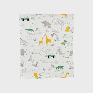 May include: White fabric with a safari-themed pattern. The design includes illustrations of giraffes, elephants, zebras, lions, crocodiles, monkeys, and green jeeps. The artwork is in black, yellow, green, and gray.