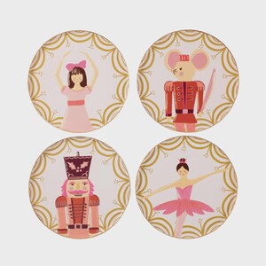 May include: Set of four round coasters featuring illustrations of characters from The Nutcracker ballet. Each coaster has a white background with a gold decorative border. The characters include a ballerina, a mouse king, and a nutcracker.