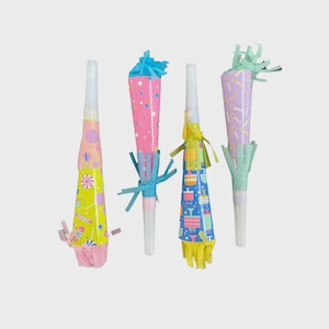 May include: Four colorful party blowers with white mouthpieces. The blowers have cone-shaped paper decorations in yellow, pink, blue, and purple, with patterns of candies, confetti, and birthday cakes. Each blower has a fringe or paper embellishment.