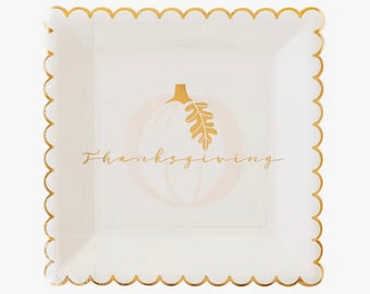 May include: White square paper plate with a gold scalloped edge. The plate features a gold pumpkin with a leaf and the text "Thanksgiving" in gold script.