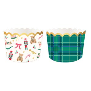 May include: Two cupcake wrappers with scalloped gold-trimmed edges. One wrapper features a cream background with a pattern of teddy bears, nutcrackers, rocking horses, trumpets, and candy canes. The other wrapper has a green plaid pattern.