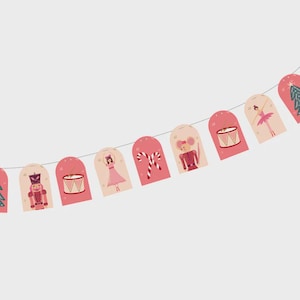 May include: A festive garland featuring pink and cream-colored arched tags. Each tag displays a different holiday-themed illustration, including a nutcracker, drum, ballerina, candy cane, and mouse. The garland is strung on a thin white string.
