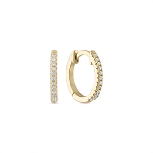 May include: A pair of gold hoop earrings with a row of small clear stones around the edge.