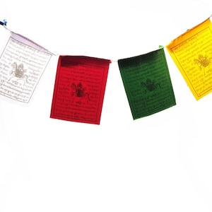 May include: Five colorful prayer flags with Tibetan writing and symbols. The flags are strung together and hanging from a white background. The flags are blue, white, red, green, and yellow.