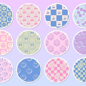 May include: A set of twelve circular stickers featuring various patterns including blue and yellow checkered flowers, pink cherries, blue checkered cherries, purple cherries, pink checkered hearts, green smiley faces, pink flowers, purple smiley faces, pink hearts, blue smiley faces, pink checkered flowers, and blue checkered flowers.