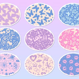 May include: A set of nine oval stickers featuring various patterns including butterflies, hearts, stars, cherries, and lips in shades of pink, purple, and blue. Each sticker has a white border and displays repeating graphic motifs on a colored background.