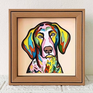 May include: A colourful, abstract, paper-cut style illustration of a dog's head in a wooden frame. The dog's fur is depicted in a variety of colours, including pink, blue, green, yellow, and orange.