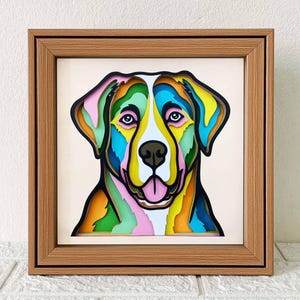 May include: A colorful, layered paper cutout of a dog's head in a wooden frame. The dog's fur is depicted in shades of green, blue, yellow, pink, and orange.