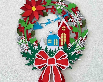 May include: A paper Christmas wreath with a red poinsettia, green leaves, white snowflakes, and a paper village scene with Santa's sleigh and reindeer.