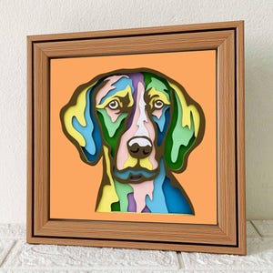May include: A colorful, layered paper cutout of a dog's head in a wooden frame. The dog's fur is a mix of green, blue, yellow, and pink.
