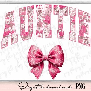 May include: Pink floral design with the word "AUNTIE" in white letters. A pink bow with a floral pattern is below the text.