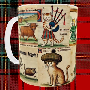 May include: A white ceramic mug with a colorful illustration of cats playing bagpipes and other Scottish imagery. The text "haggis" is visible on the mug.