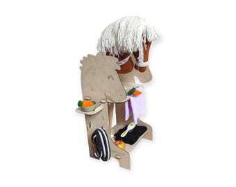 May include: Wooden toy horse playset with a white mane and brown head, a purple towel, a black saddle, a green brush, a carrot, and an apple. The playset is designed for children to play pretend.