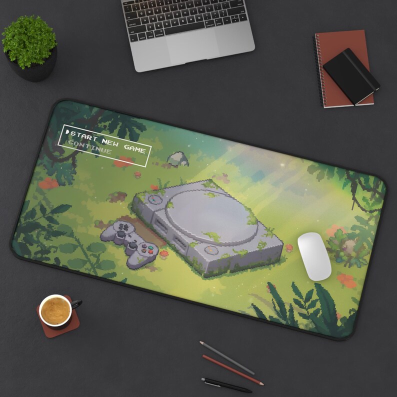 Pixel art gaming mousepad featuring a grey retro 90s console overgrown with vines in a sunny forest. "Start New Game" menu text overlay. Cozy green aesthetic desk mat for retro gamers.