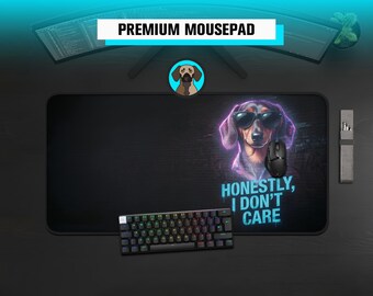 May include: A rectangular black mousepad featuring a graphic of a dachshund wearing sunglasses with a purple neon outline. The text "HONESTLY, I DON'T CARE" is printed in cyan below the dog. A black computer mouse and a mechanical keyboard are placed on top.
