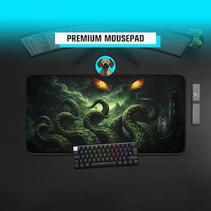 May include: A black rectangular mousepad with a green and black kraken design, a black keyboard, and a black mouse. The mousepad has the text "PREMIUM MOUSEPAD" in white. A dog logo is in the center.
