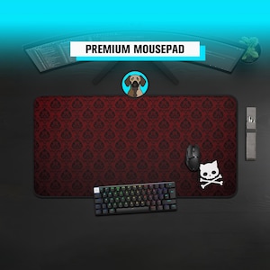 May include: A black and red damask patterned mousepad with a black keyboard, mouse, and a white cat skull and crossbones sticker. The mousepad has the text "PREMIUM MOUSEPAD" on it.