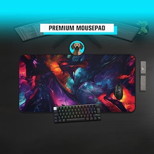 May include: A large rectangular mousepad with a vibrant abstract design in shades of red, orange, purple, and blue. The mousepad has the text "PREMIUM MOUSEPAD" in a white banner. A black mouse and keyboard are on the pad.