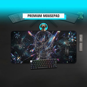 May include: Black rectangular mousepad featuring a skull design, a black keyboard, and a black mouse. The skull is composed of geometric shapes against a galaxy backdrop. The text "PREMIUM MOUSEPAD" is displayed on the top.