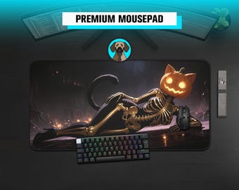 May include: A rectangular mousepad featuring a graphic illustration of a skeleton with a glowing jack-o'-lantern head and cat ears, lying in a reclining pose. The design includes gold-coloured bones against a dark background. The text PREMIUM MOUSEPAD is visible above the mousepad.