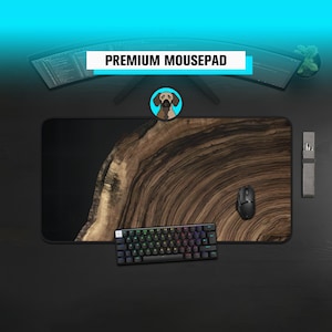 May include: A large rectangular mousepad with a wood grain design and a black border. The mousepad has a black mouse, a keyboard with rainbow-coloured keys, and the text "PREMIUM MOUSEPAD".