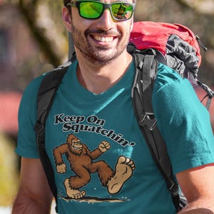Colorful Bigfoot &quot;Keep On Sqatchin&#39;&quot; T-Shirt, Sasquatch Tee Shirt, Unisex Heavy Cotton Top, Custom Graphic Design, Gift for Cryptid Lovers