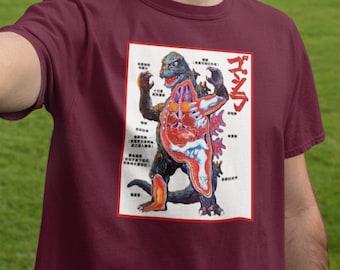 May include: A maroon t-shirt with a white graphic of a Godzilla-like creature with its internal organs visible. The graphic is labeled in Japanese with the word "ゴジラ" (Godzilla).
