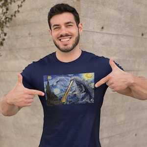 May include: A navy blue t-shirt with a graphic print of a monster from the movie Godzilla superimposed on a painting reminiscent of Vincent van Gogh's Starry Night.