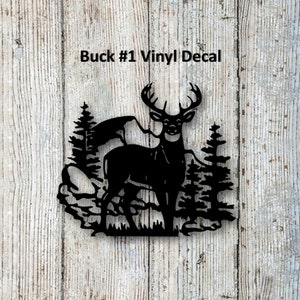 May include: Black vinyl decal of a buck standing in a forest with trees and rocks. The decal says "Buck #1 Vinyl Decal".