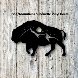 May include: Black silhouette vinyl decal of a bison with mountains and a moon inside its body. The decal has a starry night sky background.