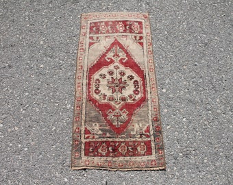 May include: A vintage red and cream runner rug with a central medallion design. The rug has a worn, distressed look and features intricate floral patterns.