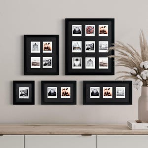 May include: A set of black picture frames with white mats, displaying various black and white photos. The frames are arranged in a grid pattern on a white wall.