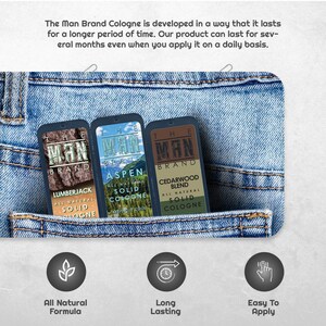 Puede incluir: Tres envases de colonia s&oacute;lida en un bolsillo vaquero. Los envases est&aacute;n etiquetados como "Lumberjack", "Aspen" y "Cedarwood Blend". Cada envase tiene el texto "The Man Brand" y "All Natural Solid Cologne". La imagen tambi&eacute;n incluye iconos para "All Natural Formula", "Long Lasting" y "Easy To Apply".