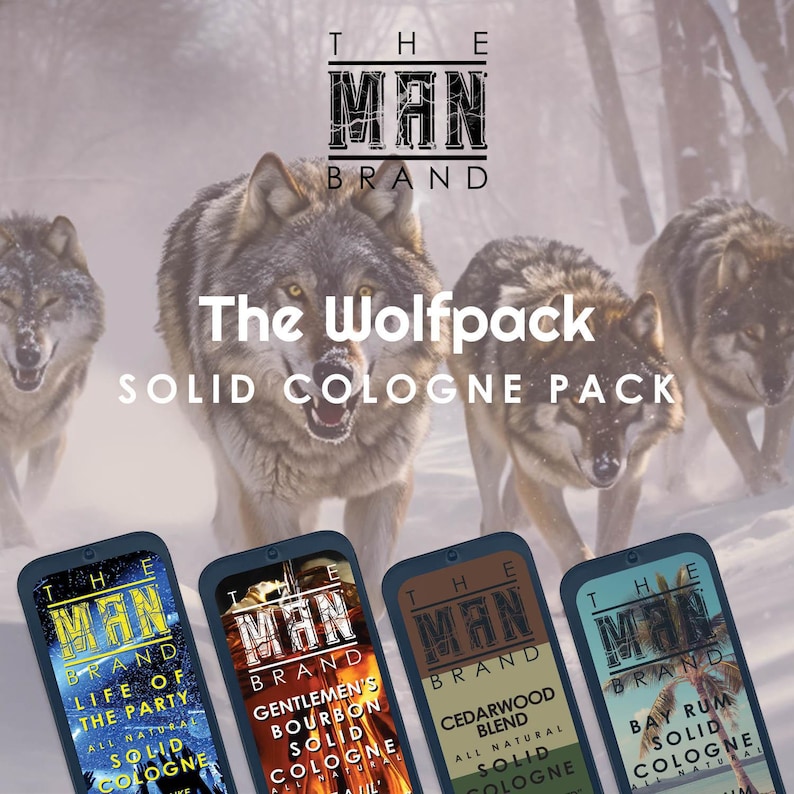 May include: The Wolfpack Solid Cologne Pack by The Man Brand. The image features four solid cologne tins with different scents, set against a backdrop of wolves in a snowy environment. The cologne tins have a dark blue border and feature the brand name and scent descriptions.