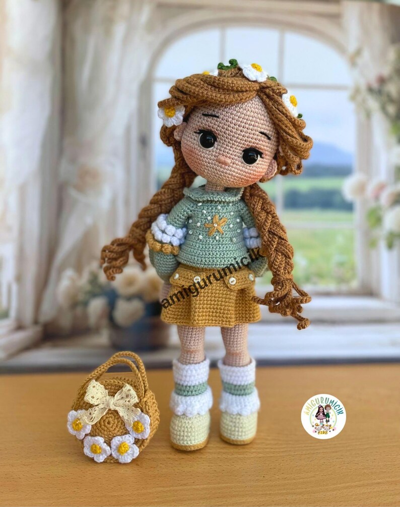 May include: Crocheted doll with long brown braids, wearing a green sweater, yellow skirt, and white socks. The doll has a floral crown and is holding a small matching purse. The text "amigurumicik" is visible.