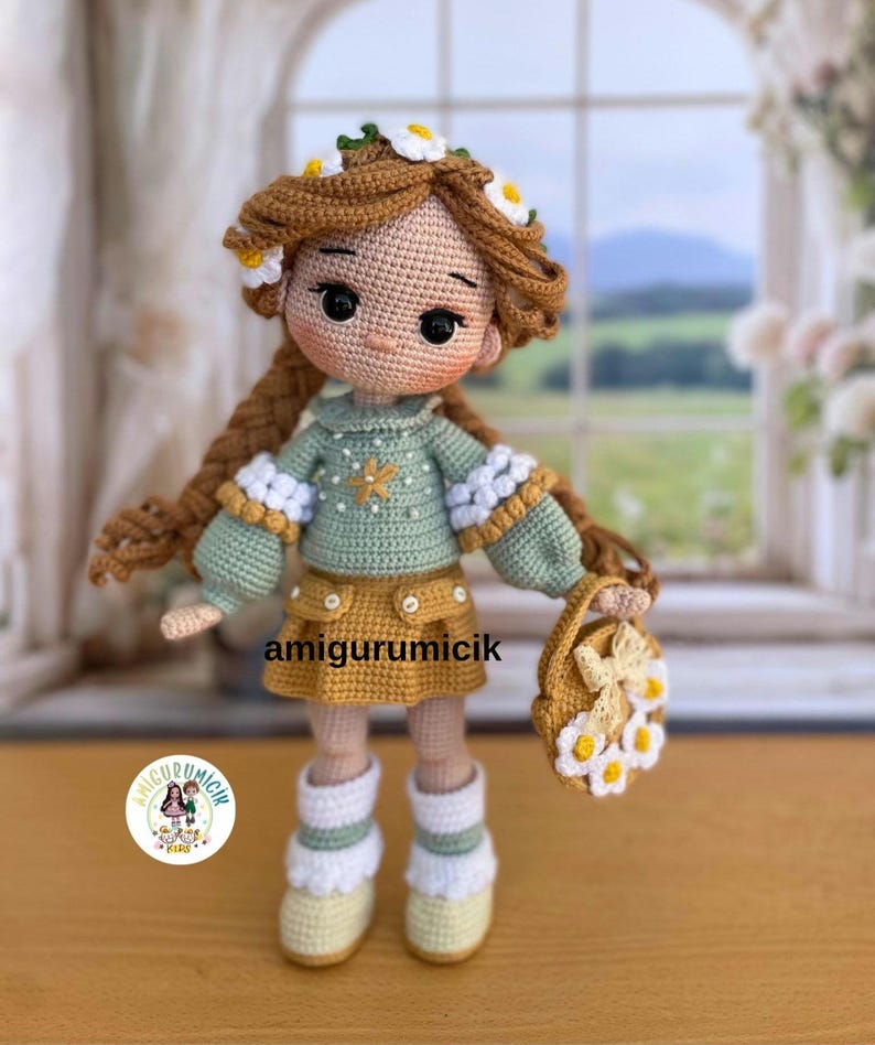 May include: A handmade crochet doll with brown hair adorned with white daisy flowers. The doll wears a green sweater, a yellow skirt, and white boots. It holds a small purse with daisy accents. The doll is approximately 8 inches tall.