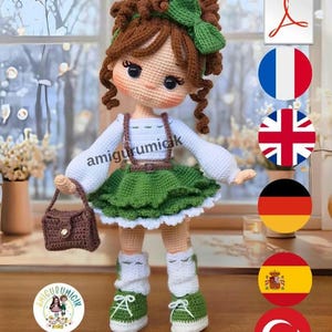 May include: A crocheted doll with brown curly hair, a green bow, and a white long-sleeved top. The doll wears a green skirt with suspenders, white socks, and green sneakers. It holds a small brown crocheted handbag. The text amigurumicik is visible.