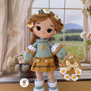 May include: A handmade crochet doll with brown hair adorned with daisy flowers. The doll wears a green sweater, yellow skirt, and white boots. A matching purse with a daisy wreath and bow is included. The text "amigurumicik" is visible on the skirt.