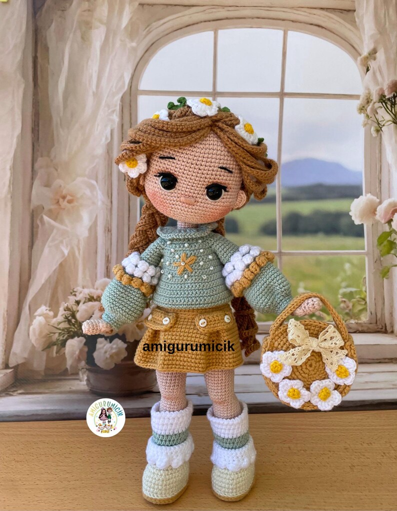 May include: A handmade crochet doll with brown hair adorned with daisy flowers. The doll wears a green sweater, yellow skirt, and white boots. A matching purse with a daisy wreath and bow is included. The text "amigurumicik" is visible on the skirt.