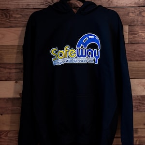 May include: Black hooded sweatshirt with a yellow and blue logo that says "Safeway Transportation Services Corp."