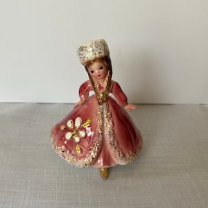 Josef Originals Russia figurine from Little International Series; girl in pink carrying grapes; ca 1960s