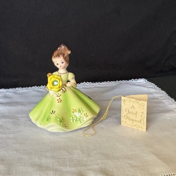 Josef Originals August Birthstone Doll figurine; Peridot; girl in green dress holding flower; Japan ca 1960s-70s; w/ original tag and labels