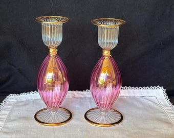 Pair of Venetian Murano iridescent pink/cranberry glass candlestick holders with gold trim; made in Italy